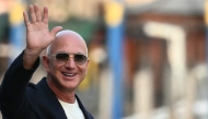 US founder of Amazon, Jeff Bezos waves as he leaves the Aman Hotel in Venice on June 25, 2026. (Photo by Marco Bertorello / AFP)