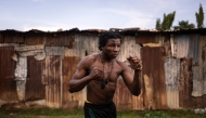 Abdullahi Ahmed, also known as Coronavirus, Dambe fighter from House Kudu, poses for a photograph in Mararaba in Nasarawa State, on June 26, 2025. (Photo by Olympia De Maismont / AFP)