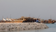 People fish in Doha on June 27, 2025. (Photo by Karim JAAFAR / AFP)