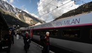 Passengers walk along a platform as train services between Modane and Saint-Michel-de-Maurienne resumed, at Modane train station in Modane, in the French Alps, on March 31, 2025. Photo by JEAN-PHILIPPE KSIAZEK / AFP