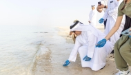 Minister of Environment and Climate Change H E Dr. Abdullah bin Abdulaziz bin Turki Al Subaie releasing hawksbill turtle hatchlings at Fuwairit Beach yesterday.