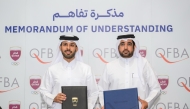 QOC Support Services Sector Director Hamad Lahdan Al-Muhannadi and Qatar Finance and Business Academy CEO Dr. Khalifa Al-Salahi Al-Yafei after signing the agreement.