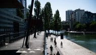 Pedestrians walk along the Canal de l'Ourcq at La Villette park as a heatwave hits Europe, in Paris on June 29, 2025. Photo by Julie SEBADELHA / AFP.

