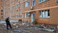 A policeman inspects debris at the bottom of a multi-storey residential building, which was damaged after a Russian drone attack in Odesa on June 28, 2025, amid the Russian invasion of Ukraine. Photo by Oleksandr GIMANOV / AFP.