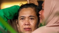 Family members and relatives wait for updates on the search operation of at least 61 people who were missing after a ferry sank off the popular Indonesian resort island of Bali, at Ketapang Port in Banyuwangi, East Java on July 3, 2025. (Photo by AFP)
