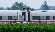 Police and forensic experts investigate a high-speed ICE train on July 3, 2025 near the village of Strasskirchen, Bavaria, after a man had attacked several passengers with 