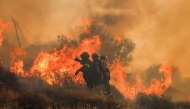 Firemen battle with a wildfire that broke out in Ierapetra at the southern Greek island of Crete, on July 3, 2025. Photo by Costas Metaxakis / AFP