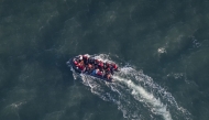 (FILES) This aerial picture taken on September 16, 2023, from a police aircraft belonging to the French Police Aux Frontieres (PAF) shows migrants onboard of a dinghy used for smuggling as they attempt to cross the English Channel to Britain from a beach at Le Touquet, northern France. (Photo by Sameer Al-DOUMY / AFP)

