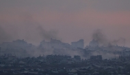 This picture taken from a position at Israel's border with the Gaza Strip shows smoke billowing after an Israeli strike on the besieged Palestinian territory on July 3, 2025. Photo by Menahem Kahana / AFP.
