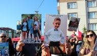 This handout photograph taken and released on July 7, 2025 by Turkish news agency DHA (Demiroren News Agency) shows families holding portraits of the victims who died on a huge fire at northern Turkish Kartalkaya Ski Resort, in Bolu on January 22, in Bolu. Photo by HANDOUT / DHA (Demiroren News Agency) / AFP