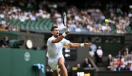 Serbia’s Novak Djokovic plays a forehand return to Italy’s Flavio Cobolli.