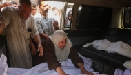 A Palestinian woman mourns a relative, killed in an overnight Israeli strike on a school, during a funeral in Jabalia in the northern Gaza Strip on July 11, 2025. (Photo by BASHAR TALEB / AFP)