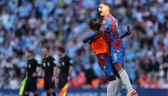 Crystal Palace's French defender #05 Maxence Lacroix (C) celebrates with teammates after the English FA Cup final football match between Crystal Palace and Manchester City at Wembley stadium in London, on May 17, 2025. Palace won the match 1-0. (Photo by Adrian Dennis / AFP)