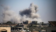 Smoke plumes rise from Israeli bombardment in Bureij in the central Gaza Strip on July 13, 2025. (Photo by Eyad BABA / AFP)
