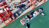A container ship arrives at the port in Lianyungang, in China. Photo by AFP