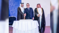 Minister of Transport H E Sheikh Mohammed bin Abdulla bin Mohammed Al Thani;  Director of Protocol at the Ministry of Foreign Affairs H E Ambassador Ibrahim Yousif Fakhroo and Chargé d’Affaires at the Embassy of France in Qatar, Patrick Poinsot cutting the ceremonial  cake to mark French National Day.