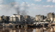 Encampments sheltering Palestinians displaced by conflict are pitched near the Sheikh Radwan wastewater collection pond, which is nearing its filling capacity, in Gaza City on July 14, 2025. (Photo by Bashar TALEB / AFP)