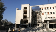 Rescuers walk inside the heavily damaged Syrian army and defence ministry headquarters complex in Damascus, following Israeli strikes on July 16, 2025. (Photo by Bakr ALkasem / AFP)