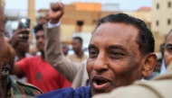 Kamil Idris, a former UN official who was appointed in May as prime minister by Sudan's de facto leader Abdel Fattah al-Burhan, addresses people and local fighters supporting the Sudanese army who came to cheer him on, during a visit in Omdurman on July 19, 2025. (Photo by Ebrahim Hamid / AFP)
