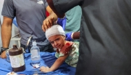 Palestinian casualties of an Israeli strike on an apartment at the Nuseirat refugee camp, receive care at Al-Awda hospital in the central Gaza Strip on July 19, 2025. (Photo by Eyad BABA / AFP)
