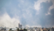 Smoke billows from Israeli bombardment as pictured from Deir el-Balah in the central Gaza Strip on July 21, 2025. (Photo by Eyad BABA / AFP)