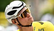 Alpecin - Deceuninck team's Dutch rider Mathieu van der Poel wearing the overall leader's yellow jersey eyes a bee flying past his head at the start of the 4th stage of the 112th edition of the Tour de France cycling race, 174.2 km between Amiens Metropole and Rouen, Northern France, on July 8, 2025. Photo by Marco BERTORELLO / AFP