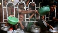 Palestinians shove to receive a hot meal at a charity kitchen in the Mawasi area of Khan Yunis in the southern Gaza Strip on July 22, 2025. Photo by AFP
