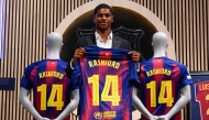 English forward Marcus Rashford who joined Barcelona on loan from Manchester United holds up his jersey during his official presentation at the Camp Nou stadium in Barcelona on July 23, 2025. (Photo by Josep LAGO / AFP)
