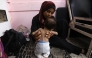 File photo of a Palestinian mother holding her two year old daughter.