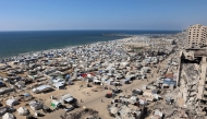 Tents and shelters for Palestinians displaced by conflict are pictured erected at a make-shift camp along the beach near the seaport in the west of Gaza City on July 19, 2025. (Photo by Omar AL-QATTAA / AFP)