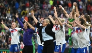 England's Dutch coach Sarina Wiegman and her players celebrate after England beat Spain to win the UEFA Women's Euro 2025 final football match between England and Spain at the St. Jakob-Park Stadium in Basel, on July 27, 2025. (Photo by Fabrice COFFRINI / AFP)

