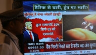 A broadcast screen of the Bombay Stock Exchange (BSE) is pictured in Mumbai on July 31, 2025, which shows the impact on the gems and jewellery sector while depicting news of US President Donald Trump unveiling sweeping new trade tariffs. (Photo by Indranil MUKHERJEE / AFP)