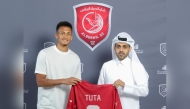 Tuta poses with an official.