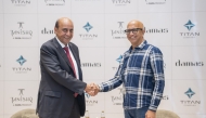 Officials pose for a picture during the announcement of acquisition. 