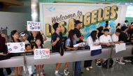 Supporters of South Korean football player Son Heung-min wait for his arrival at the Los Angeles International Airport in Los Angeles, California on August 5, 2025. (Photo by Patrick T. Fallon / AFP)