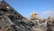 Palestinians inspect the damage after an overnight strike on the Sheikh Radwan Health Centre in the north of Gaza City on August 6, 2025. (Photo by Omar Al-Qattaa / AFP)