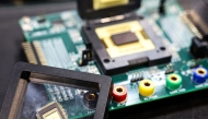 (Files) A sample of a semiconductor chip made by Taiwan Semiconductor Manufacturing Company (TSMC) is displayed at the Cybersec 2025 conference and expo in Taipei on April 15, 2025. (Photo by I-HWA CHENG / AFP)
