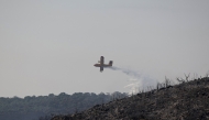 A Canadair aircraft of the French civil security drops fire retardant over a wildfire in Villeseque-Corbieres, southern France on August 7, 2025. Photo by Valentine CHAPUIS / AFP.
