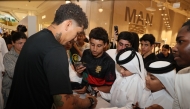 Al Sadd’s Roberto Firmino signs autographs for fans during the Qatar Stars League's promotional event in Lusail yesterday.