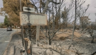 This photograph shows a burned entrance sign following wildfires in Durban-Corbieres, in the Aude department, southern France on August 9, 2025. (Photo by Idriss Bigou-Gilles / AFP)