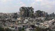 Buildings destroyed in Israeli strikes surround makeshift shelters for displaced Palestinians in Gaza City on August 8, 2025. (Photo by Bashar TALEB / AFP)
