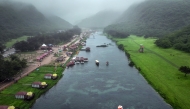 An aerial picture shows a touristic spot on the Wadi Darbat lake in the region of Dhofar, near Oman's Salalah city on July 25, 2025. (Photo by AFP)

