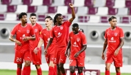 Al Duhail’s Ibrahima Bamba raises his hand in celebration after scoring the equaliser, joined by his teammates. PIC: AFC