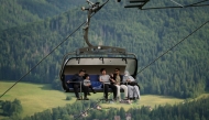 Tourists sit in a chairlift on the hill Gubalowka, a hill from which there is a view of Zakopane and the Tatra Mountains, on August 4, 2025. (Photo by Bartosz Siedlik / AFP) 