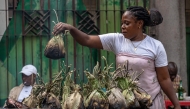 A vendor grills liboke in Kinshasa on August 7, 2025. (Photo by Hardy Bope / AFP)