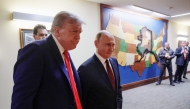 In this pool photograph distributed by the Russian state agency Sputnik, US President Donald Trump (L) and Russian President Vladimir Putin (R) walk to hold a joint press conference following a US-Russia summit on Ukraine at Joint Base Elmendorf-Richardson in Anchorage, Alaska, on August 15, 2025. (Photo by Gavriil GRIGOROV / POOL / AFP)
 