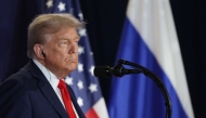 In this pool photograph distributed by the Russian state agency Sputnik, US President Donald Trump listens to Russian President Vladimir Putin during a joint press conference after participating in a US-Russia summit on Ukraine at Joint Base Elmendorf-Richardson in Anchorage, Alaska, on August 15, 2025. (Photo by Gavriil GRIGOROV / POOL / AFP)