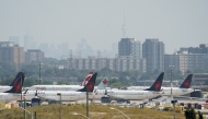 Air Canada airplanes stand on the tarmac at Pearson International Airport in Toronto on August 16, 2025. Photo by Peter POWER / AFP.
