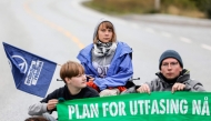 Swedish climate and political activist Greta Thunberg (C) and activists from the climate protest group Extinction Rebellion take part in a protest at Equinor's oil refinery in Mongstad, north of Bergen, Norway on August 18, 2025. Photo by Paul S. Amundsen / NTB / AFP