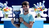 Carlos Alcaraz of Spain poses with the Rookwood Cup after his win over Jannik Sinner of Italy during the men's final of the Cincinnati Open at Lindner Family Tennis Center in Mason, Ohio, on August 18, 2025. (Photo by Matthew Stockman/Getty Images/AFP)